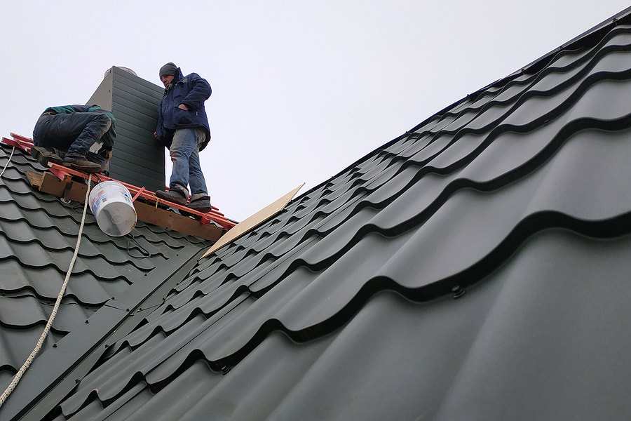 wokers repairing the metal roof